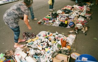 a person standing next to a pile of trash