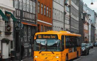 yellow and black bus on road at daytime