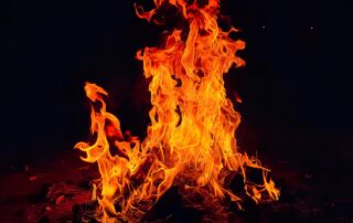 a fire blazing in the dark on a black background