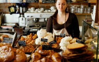 woman on counter near breads