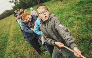 group of children pulling brown rope