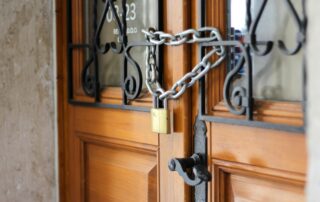 grey metal chain on brown wooden door